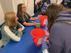 ASC members Rachel Geisler and Aubrey Kress              run a booth for people to donate money for coaches vs.cancer and guess the number of M&Ms in a jar for a prize.  