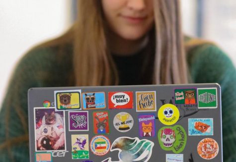Brianna Dierks has a wide variety of stickers on her chromebook. The cat astronaut sticker on the left is her favorite sticker being displayed.