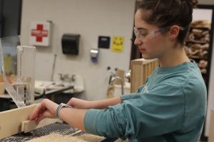 Senior Maggie Merz works on a project in her woods class.