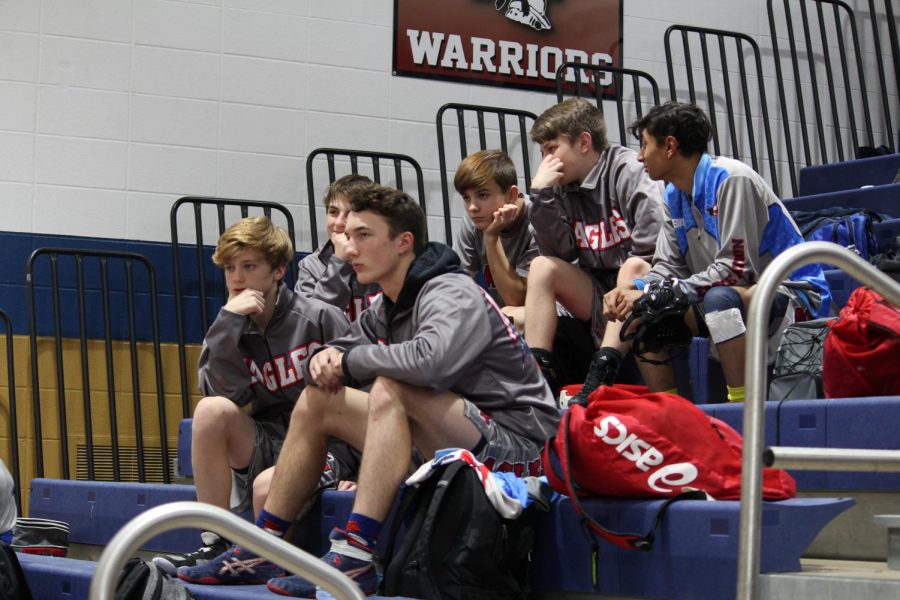 Wyatt Haynes hangs out with his fellow varsity wrestlers during the first part of the meet.