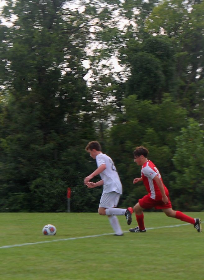 Jackson Westrich (right) tries to get possession of the ball against a Francis Howell North player in a match on Sept. 10. Liberty won the game, 3-2. 