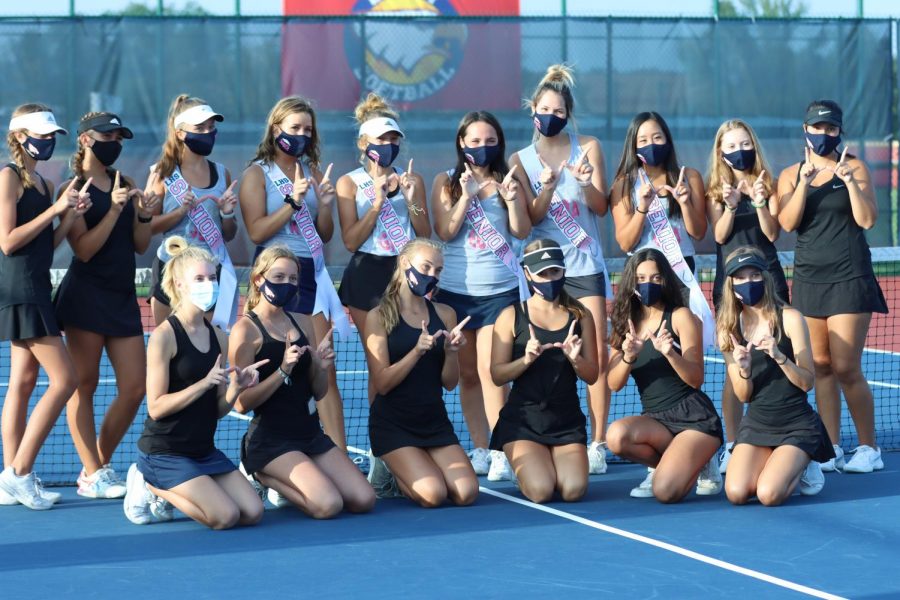 The varisty tennis team poses with there seniors. The seniors chose to wear black during senior night.