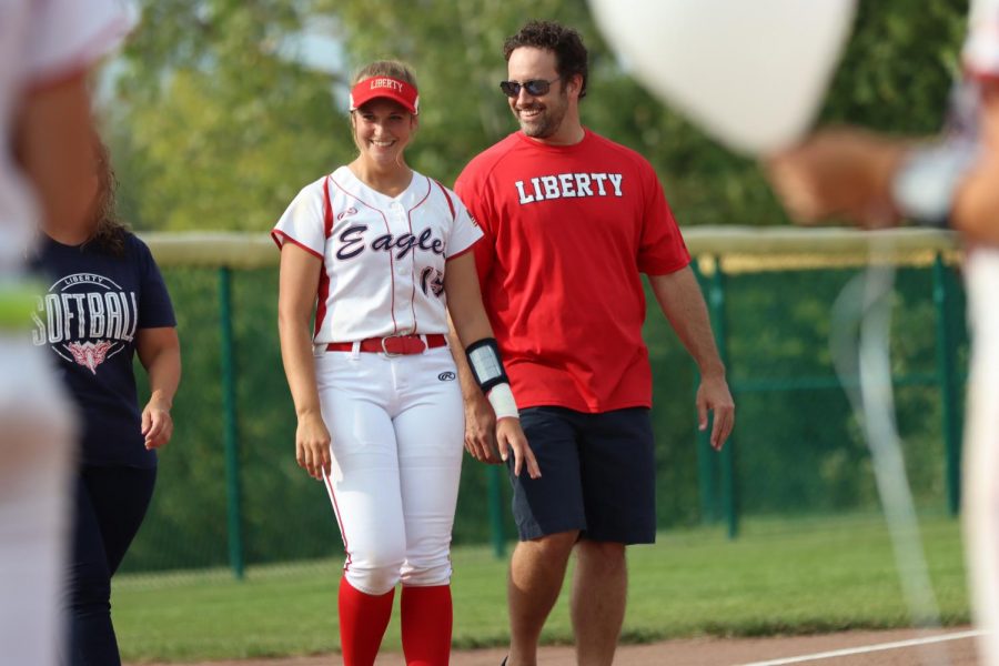 Kendall Weber (12) grins big as she stands next to her dad.