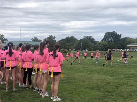 2019-2020 seniors stand on the sidelines, cheering on their teammates at last years powder puff game.