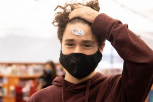 Junior Keaton Roof displays his “I Voted” sticker on his forehead.