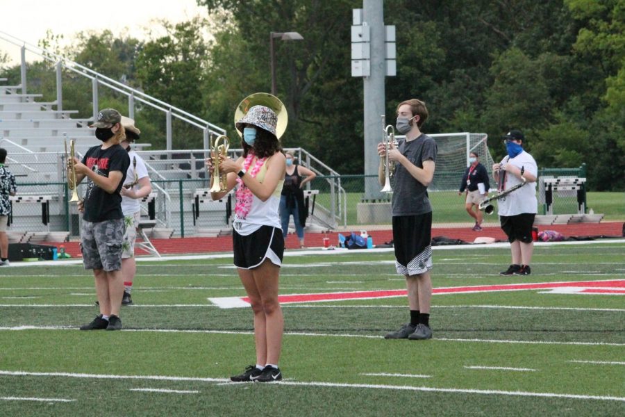Marching band practices earlier this season with COVID-19 restrictions, on a beach-themed spirit day.