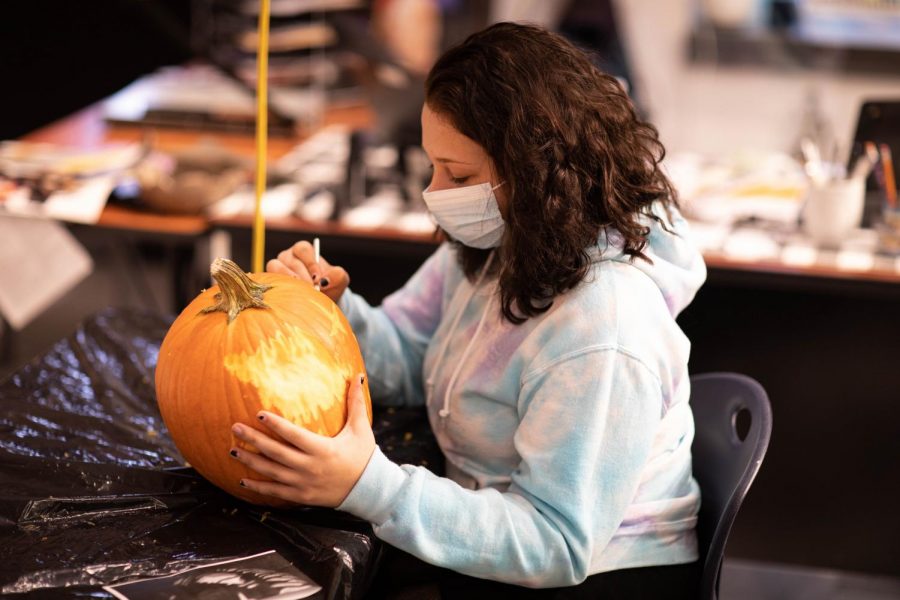 Third place winner Kiley Lang carves her pumpkin. 