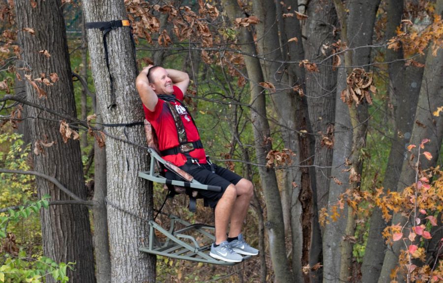 Coach Jolliff demonstrates how to climb a tree to his Outdoor Pursuits class. He makes sure to explain how to use the portable tree stand in detail.
