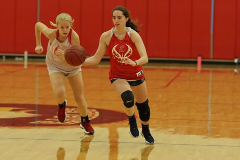 Sara Gordley (12) on a fast break being chased by Dori Earle (11) at an early season practice.