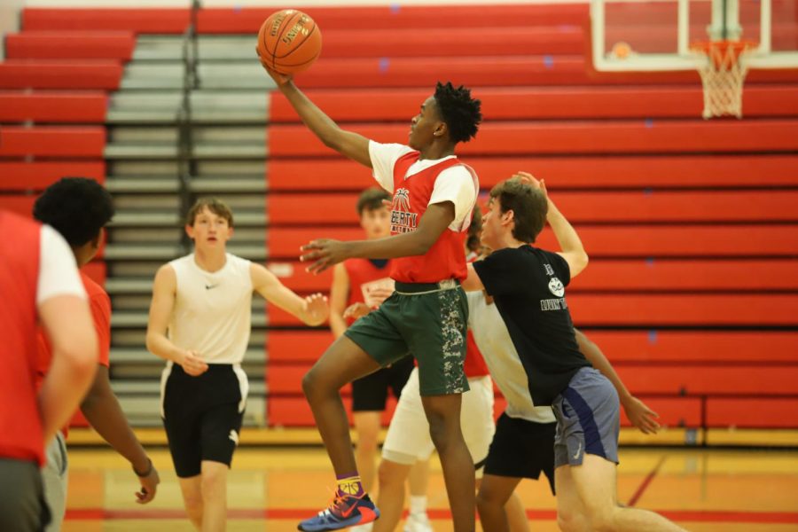 Jaden Benton(11) goes in for a layup in a scrimmage.