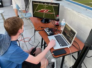 Jayce Haun (10) uses OBS (a live-streaming software) to prepare for the streaming of the football game.