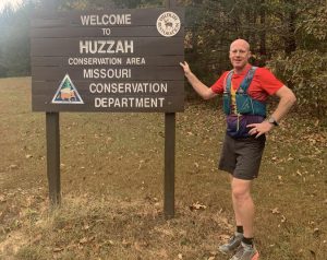 Mr. Eldredge stands next to the Huzzah Conservation area sign, where he finished his race. 
