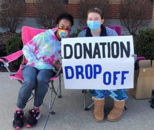 Volunteers Leilani Green (9) and Olivia Guffey (12) at the donation drop-off the outreach committee hosted