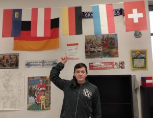 Jax Drezek points to a German flag in Mr. Stolls room.