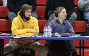 Tyler Metheney (11) and Katie Swanson (12) do live commentary at the girls basketball game.