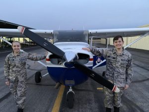 Jaxon Drezek and his partner Alexandria Hammack stand in front of the Cessna Skyhawk 172.