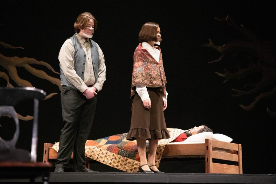 Thomas and Ann Putnam (Michael Gannon and Morgan Feinstein) observe the declining condition of the sick Betty Parris (Chynna Yeh).