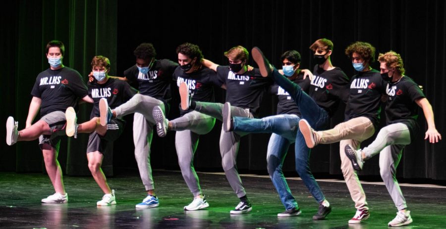 Mr. LHS contestants form a kickline during their performance.  