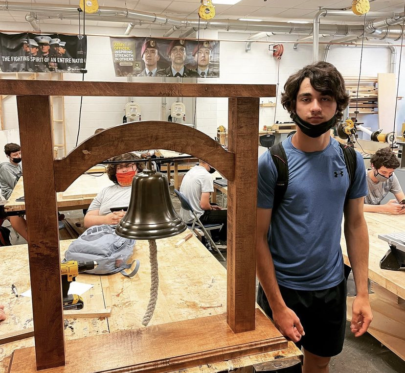 Sophomore Vito Signaigo poses with his recently created Liberty bell stand. 