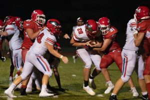 Ethan Weiler gains yardage on a running play in the fourth quarter against Warrenton. Weiler led the Eagles with 86 rushing yards. 