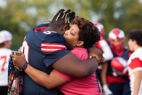 Kevin Lyles hugging his mother Nellie at Senior Night. KJ plans to continue playing football after graduation.