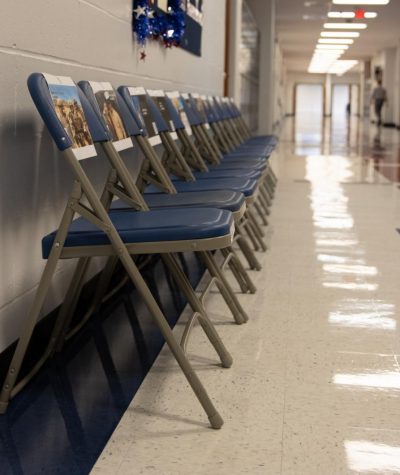 Teachers in 400 hallway set up 13 chairs for the fallen who died in Afghanistan.