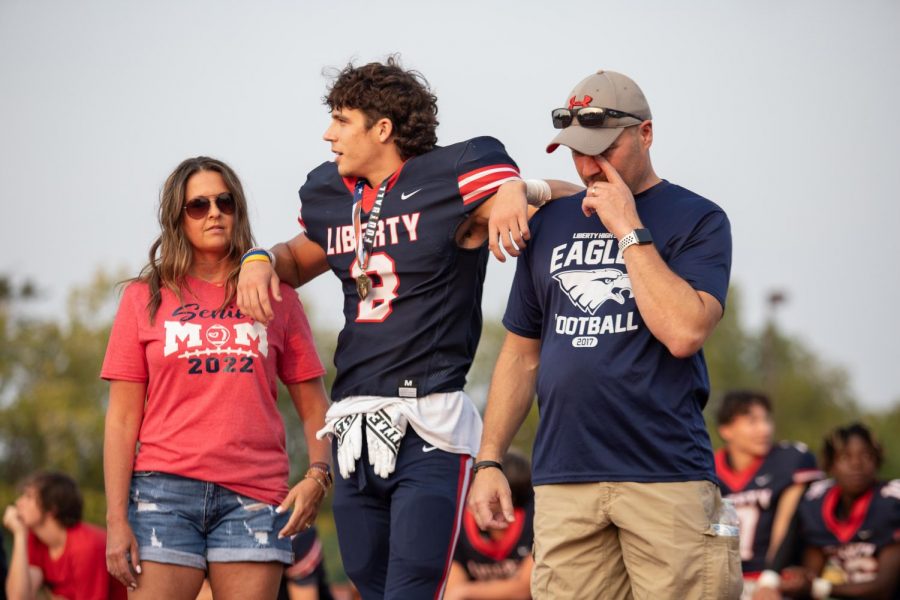 Senior Jacob Sorge watches as his team mates are escorted by their parents.
