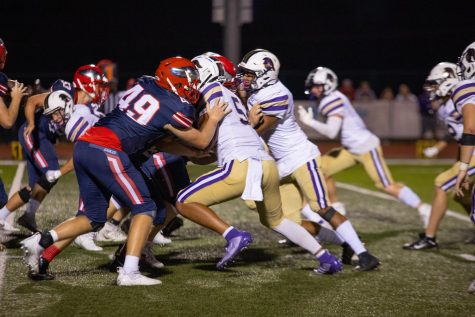 Henry Ragsdale (49) blocks on a play while Liberty moves the ball on offense. 