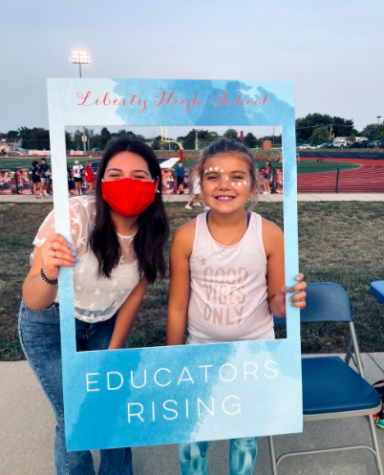 Educators Rising President Athena Widlacki (12) poses with a freshly painted Eagles fan.
