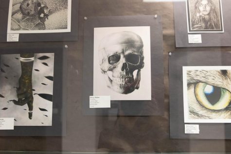 A sketch of a skeleton by Maryn Weber featured in the art display case. 