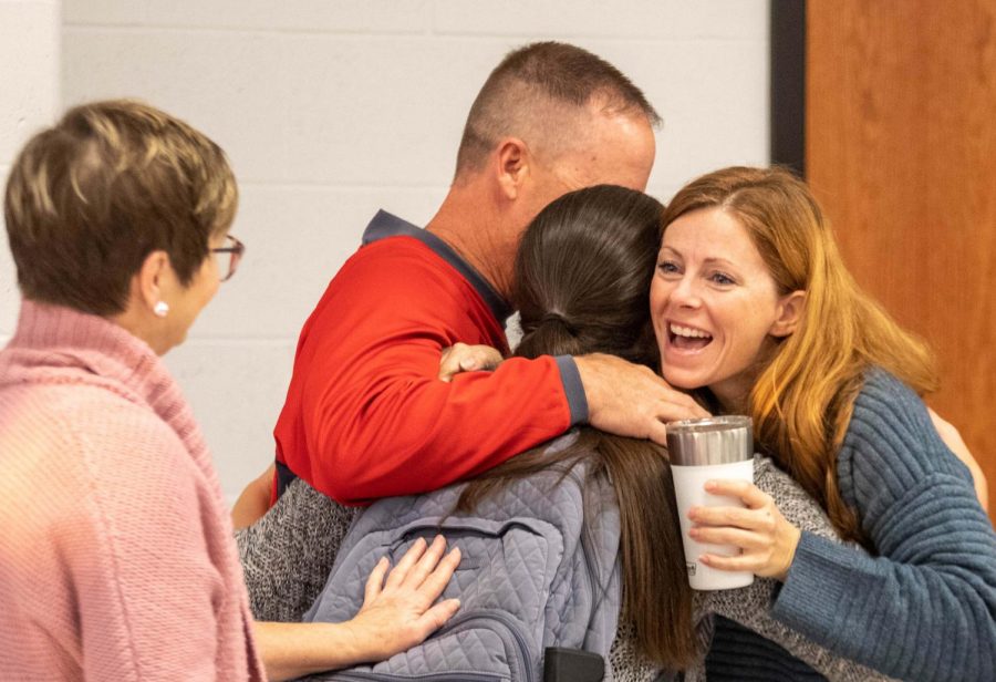 Ms. Pizzo, Mr. Jolliff and Ms. Huesgen embrace Ms. Jolliff after hearing the great news.