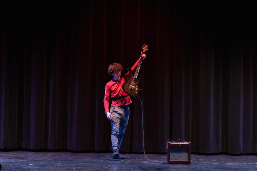 Collin Fay (12) holds aloft his electric guitar after providing a medley of popular songs. 