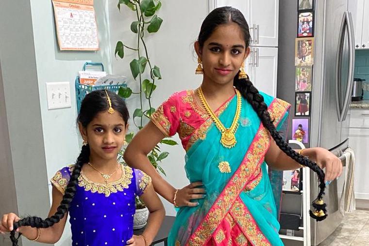 Divya Kollipara wearing her cultural clothing with her younger sister.