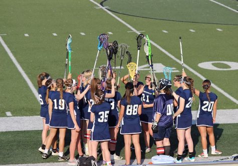 Wentzville GIrls lacrosse team chants their name in preparation for a big game.