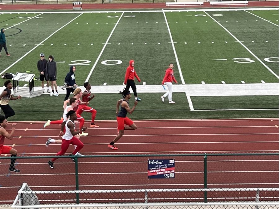 David Richard (12) in the lead in the 100 meter sprint at the opening track meet. He won the race with a time of 11.87 seconds.