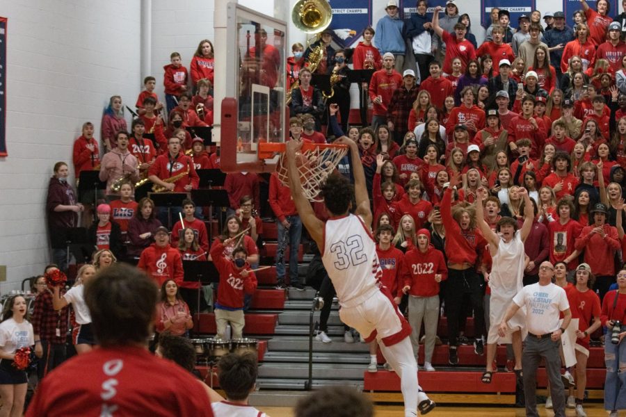 Senior Adrian Lee dunks the ball while the crowd roars in celebration in the game against South.