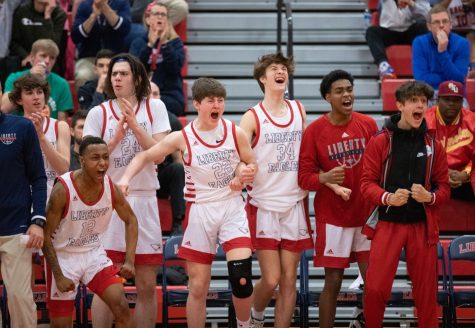 The boys team celebrates a Liberty bucket during the second half of the game.