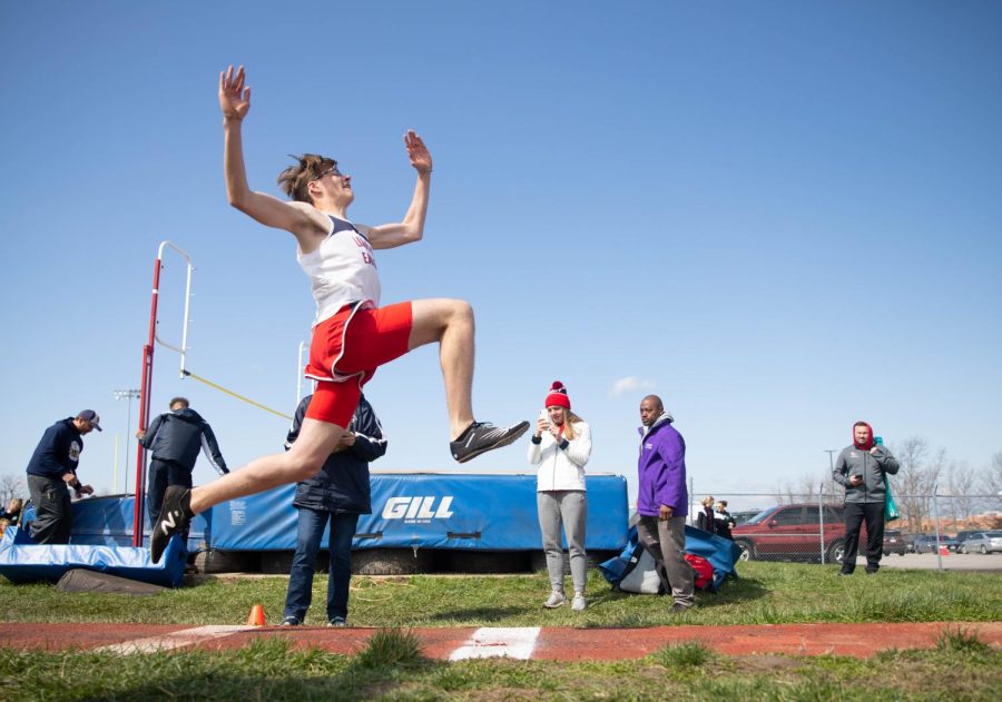 Liberty sophomore Conner Place competes in the long jump at the Varsity Pow Wow meet at Holt High. Long jump requires a lot of power and technique and thats what makes it interesting. You have to have a good approach, a good jump, and a good landing in order to have a great jump, Place said. His personal best is a jump of 5.98 meters.