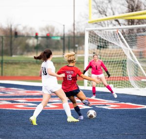 Morgan Struttmann (11) takes a shot on goal in a previous game. Struttmann scored the first of two goals against St. Dominic and has scored 18 goals so far this season.
