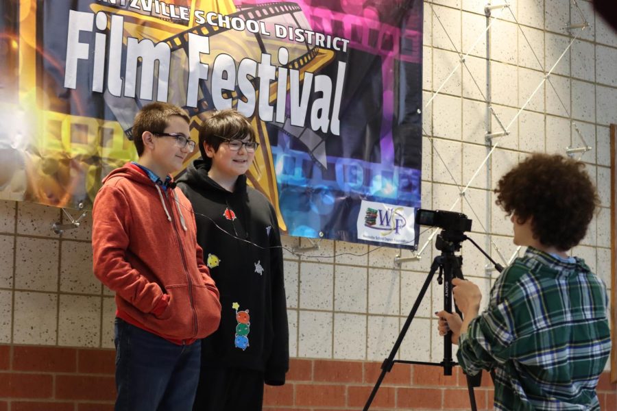 Two students being interviewed by a Holt journalism student outside the North Point Auditorium.