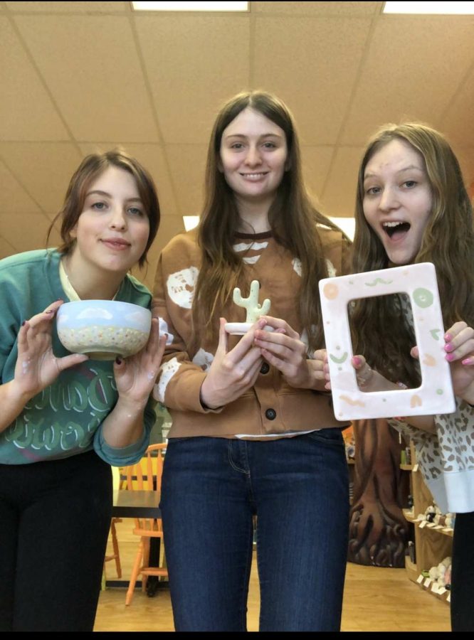 (Left to Right) Seniors Mollie Banstetter, Paige Bostic and Avery Schlattman pose with their Pottery Hollow glazed ceramics. 