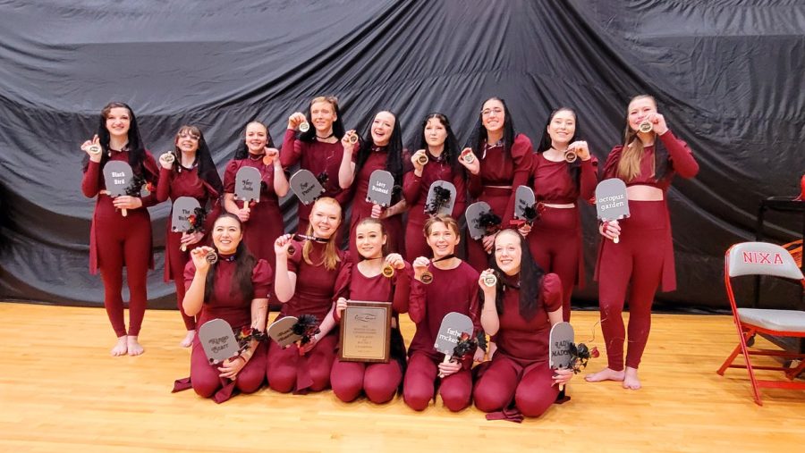 The Winter Guard team poses with their championship plaque and individual gold medals.