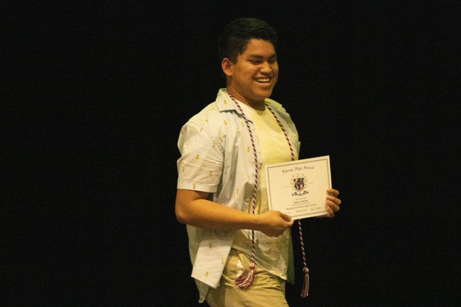 Jaden Zelidon posing with his certificate and cord of Departmental Excellence for science. Zelidon also received the departmental honor for instrumental performing arts.