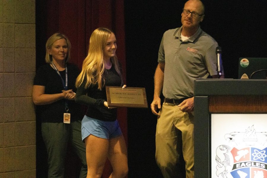 Allison Kruger is given the St. Louis Post-Dispatch Scholar Athlete Award by Liberty athletic director Cary Eldredge. Kruger was the first girls cross country state champion in the history of Wentzville School District.