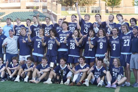 The Wentzville lacrosse team poses for a picture with their Show-Me Cup trophy.