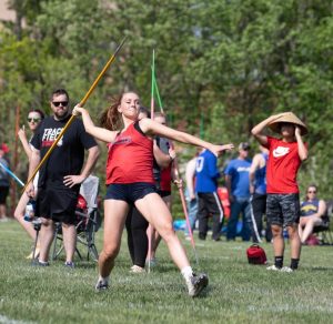 Savannah Meyer (11) steps to throw a javelin. Meyer placed third overall at the district meet. 