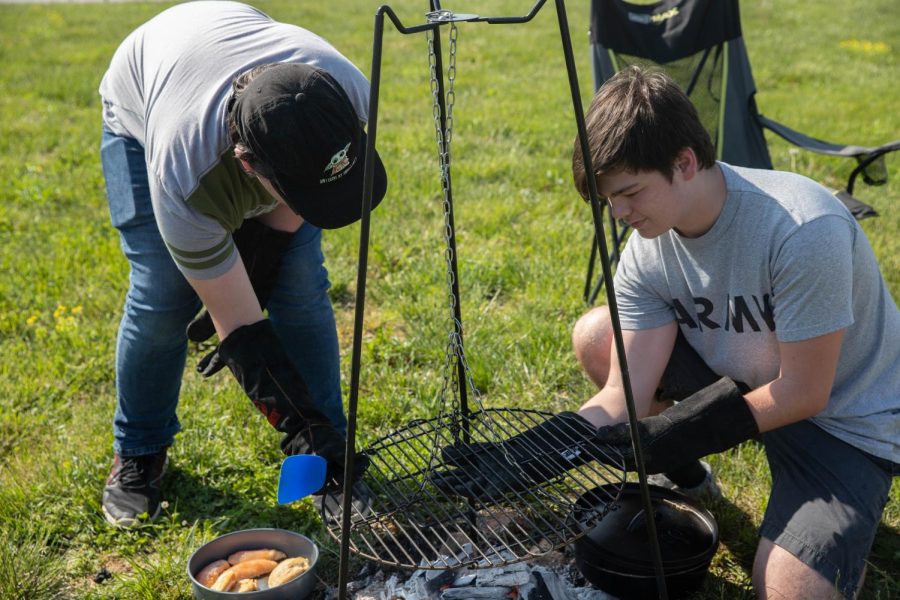 Camden LaVallee (right) cooks chicken over a handmade Dutch oven in Outdoor Pursuits on May 12. 