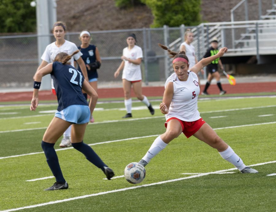 Maddy Kuhn (10) puts a stop to St. Dominics momentum on an offensive attack by swiping the ball and clearing it out.
