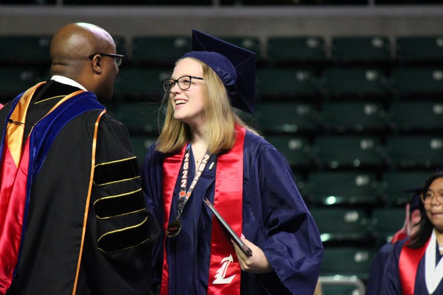 Kylie Pashia shakes hands with superintendent Dr. Cain after receiving her diploma. 