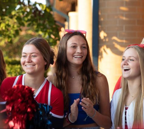 Carlie Boucher (12), Ava Swift (12) and Haylie Aubuchon (11) greet students as they enter the building on the first day of school. 